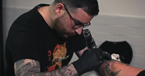 Close up tattoo artist shows the process of getting tattoos with paint. Stock Footage 236339198