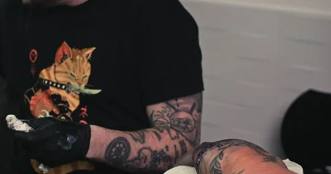 Close up tattoo artist shows the process of getting tattoos with paint. Stock Footage 236339477