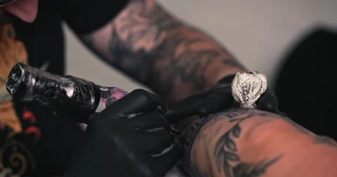 Close up tattoo artist shows the process of getting tattoos with paint. Stock Footage 236339541