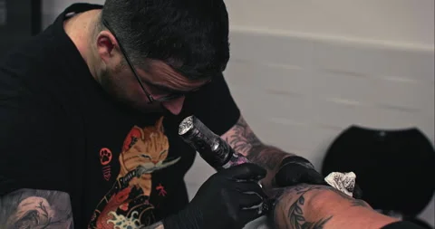 Close up tattoo artist shows the process of getting tattoos with paint. Stock Footage 236339702