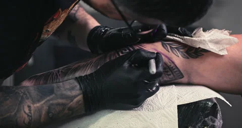 Close up tattoo artist shows the process of getting tattoos with paint. Stock Footage 236339863