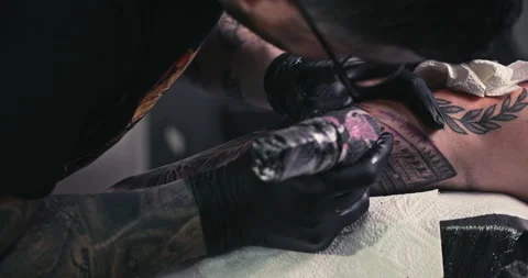 Close up tattoo artist shows the process of getting tattoos with paint. Stock Footage 236340405