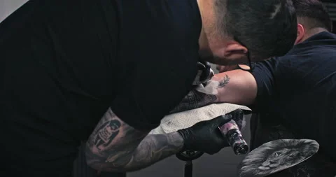 Close up tattoo artist shows the process of getting tattoos with paint. Stock Footage 236340614