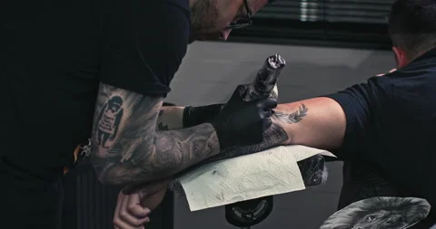 Close up tattoo artist shows the process of getting tattoos with paint. Stock Footage 236340636