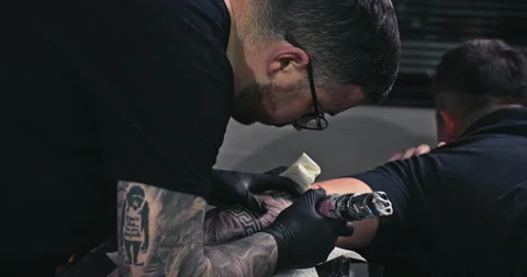 Close up tattoo artist shows the process of getting tattoos with paint. Stock Footage 236340796