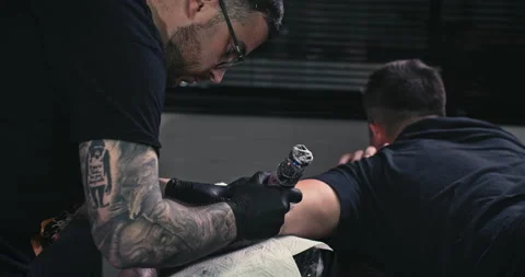 Close up tattoo artist shows the process of getting tattoos with paint. Stock Footage 236340820