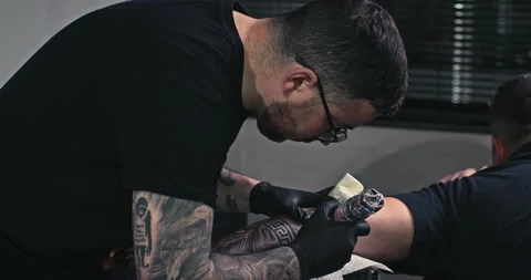 Close up tattoo artist shows the process of getting tattoos with paint. Stock Footage 236340843