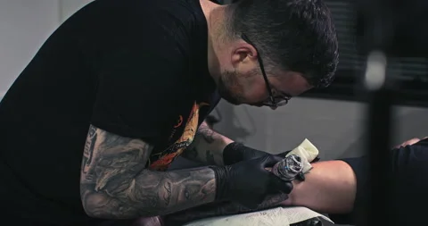 Close up tattoo artist shows the process of getting tattoos with paint. Stock Footage 236340953