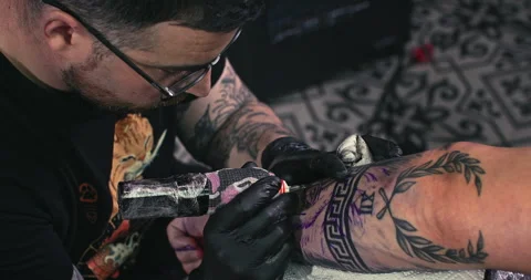 Close up tattoo artist shows the process of getting tattoos with paint. Stock Footage 236348632