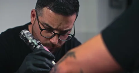 Close up tattoo artist shows the process of getting tattoos with paint. Stock Footage 236348721