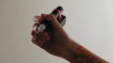 Close-up of a tattoo artist's hand with a typewriter Stock Footage 184042875