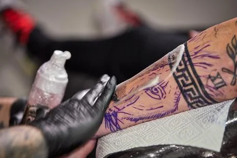 Close the tattoo machine. Tattoo image on arm by a professional tattoo artist Stock Photos