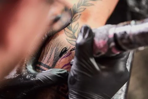 Close the tattoo machine. Tattoo image on arm by a professional tattoo artist Stock Photos