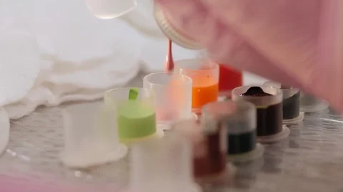 Close-up of a tattoo master pours multicolored ink into special containers. Stock Footage 126931455