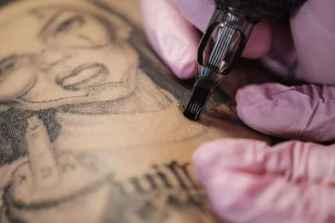 Close-up of a tattoo needle. The process of the tattoo master. Pink women's Stock Photos