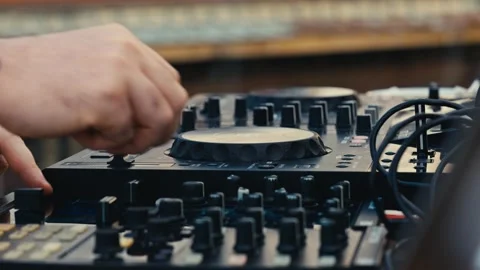 Close Up of Tattooed DJ Hands Adjusting Knobs and Faders on Sound Controller Stock Footage 343326288
