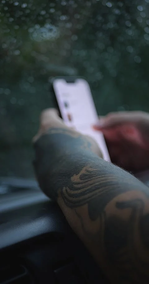 Close-Up Of Tattooed Hand Using Smartphone In Car During... Stock Footage 332075648