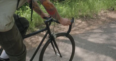 Close-up of tattooed hands gripping handlebars Stock Footage 311934535