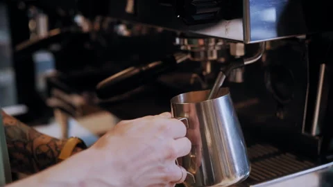 Close-Up of Tattooed Hands Steaming Milk on Espresso Machine Stock-Footage 307595593