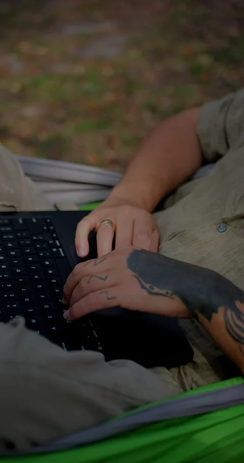 Close-Up Of Tattooed Hands Typing On A Laptop Keyboard... Stock Footage 331820814