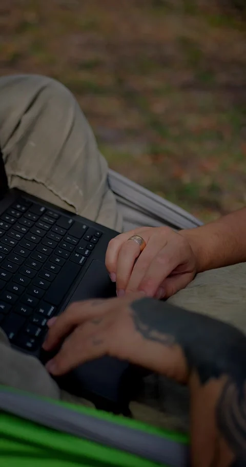 Close-Up Of Tattooed Hands Typing On A Laptop Keyboard... Stock Footage 331820831