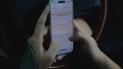 Close-up of tattooed hands using a smartphone inside a car... Stock Footage 341613026