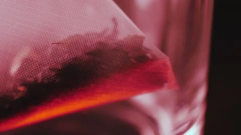 Close-up of a tea bag in an empty transparent cup with a smooth camera movement Stock Footage 184475820