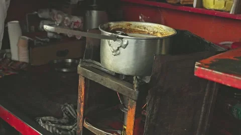 A close-up of tea boiling or tea preparation on the stove at a local tea stal Stock Footage 245275407