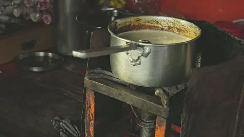 A close-up of tea boiling or tea preparation on the stove at a local tea stal Stock Footage 245275433