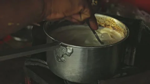 A close-up of tea boiling or tea preparation on the stove at a local tea stal Stock Footage 245275451