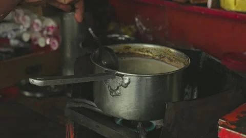 A close-up of tea boiling or tea preparation on the stove at a local tea stal Stock Footage 245275513
