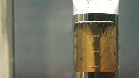 Close-up of tea leaves floating in boiling water in a tea pot.  Stock Footage 88986858