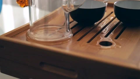 Close-up Tea master pours white elite tea leaves into a glass teapot. Stock Footage 220341823