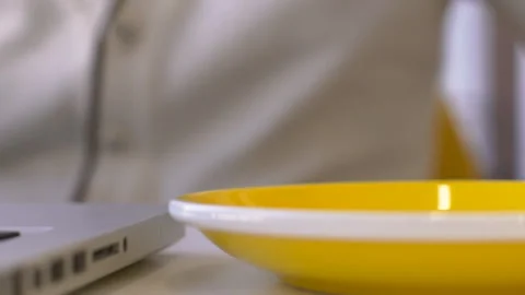 Close up of tea mug is being put onto the plate in moderm cafe. Stock Footage 85620874