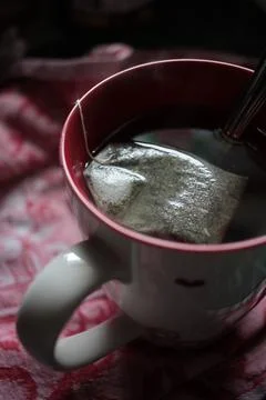 Close-up of a teabag brewing in a cup of tea Stock Photos
