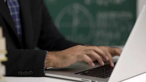 Close up teacher man sitting teaching online video conference live stream by lap Stock Footage 153505423