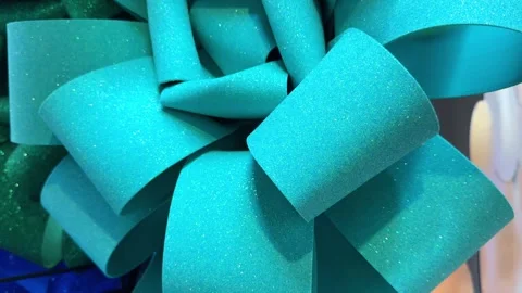 Close-up on teal glittery gift bow rotating Stock Footage 292320087