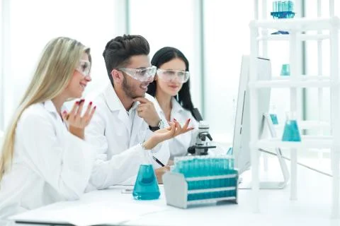 Close up.a team of scientists use a computer to check the data Foto stock