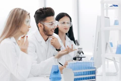 Close up.a team of scientists use a computer to check the data Stock Photos