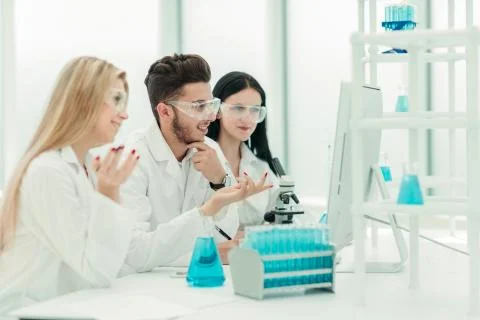 Close up.a team of scientists use a computer to check the data 写真素材