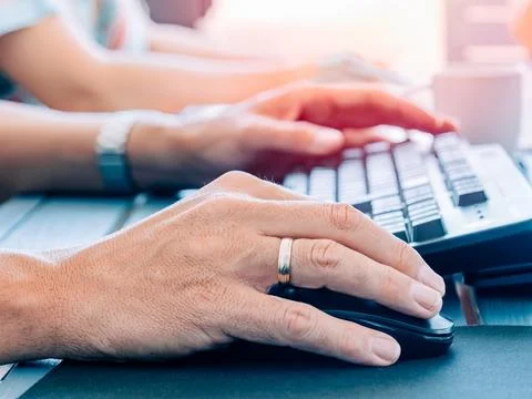 Close-up of teamwork on desktop computers Stock Photos
