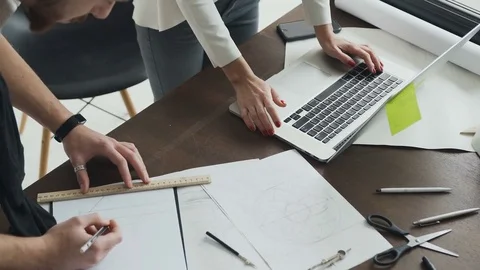 Close-up .Teamwork of two architects in the office. Planning design Changes in Stock Footage 82997786