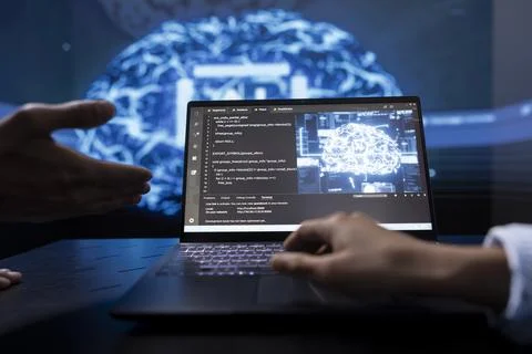 Close up of teamworking IT experts using artificial intelligence on notebook Stock Photos