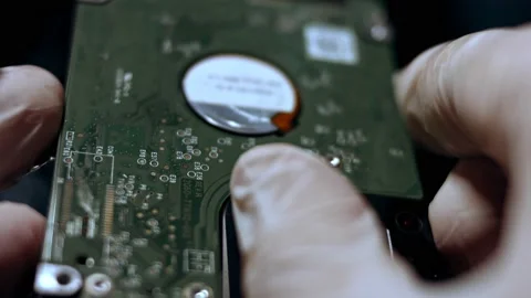 Close-up of a technician analizying the HDD from notebook. Slowmotion Stock Footage 143162501