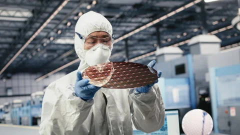 Close up of technician analyzing silicon wafer in microchip factory Stock Footage 333391717