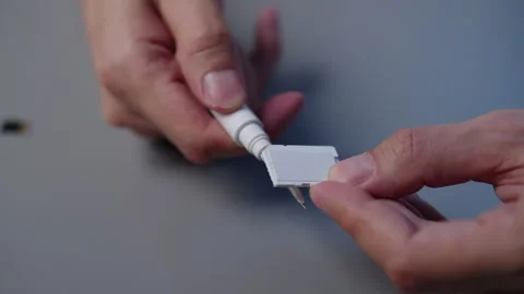 Close-up of technician cleaning adapter contacts from memory card using Stock Footage 318747695