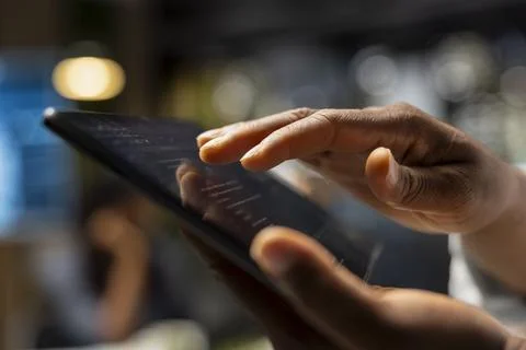 Close up of technician coding with tablet in startup office Stock Photos