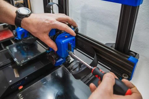Close-up of technician doing 3D printer repair. Stock Photos