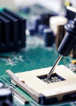 Close Up - Technician engineer measuring multimeter CPU socket motherboard Stock Photos