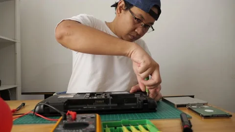 Close up of technician engineer trying to repairing broken laptop. Computer r Stock Footage 152717457